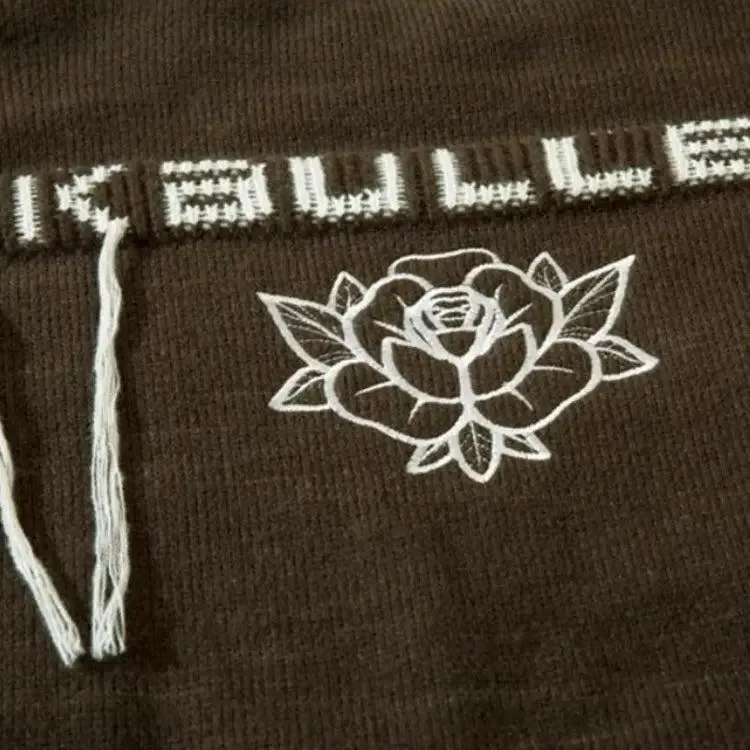 Grunge-Inspired Sweater with Distressed Details and Pink Accents