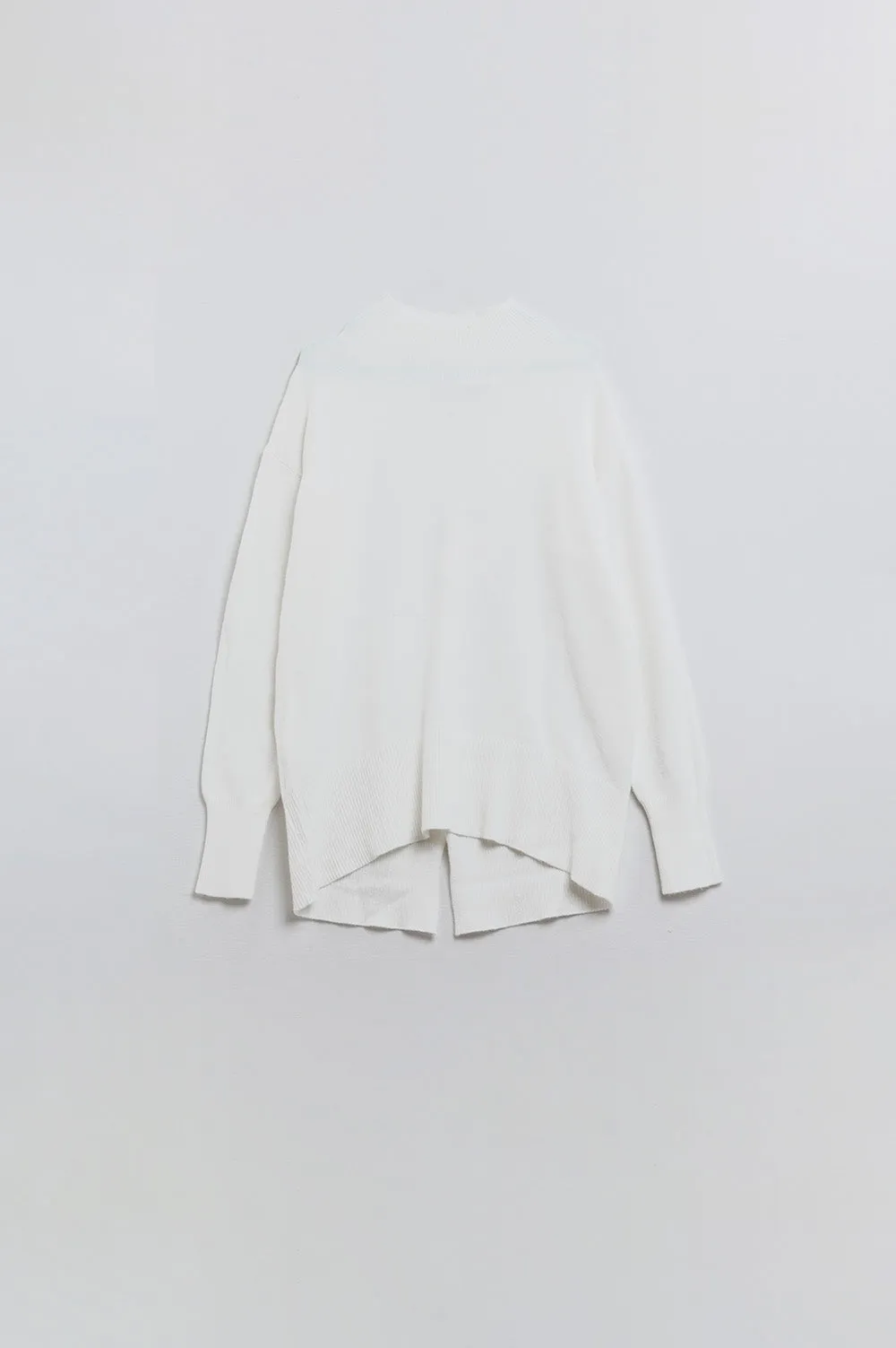 Loose white sweater with open back detail