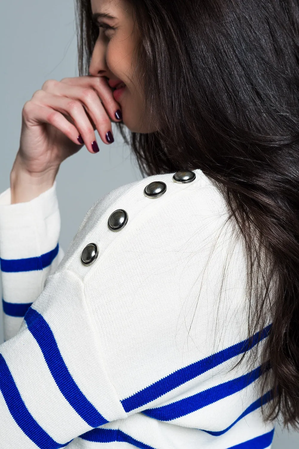 White sweater with buttons on shoulders and blue stripes